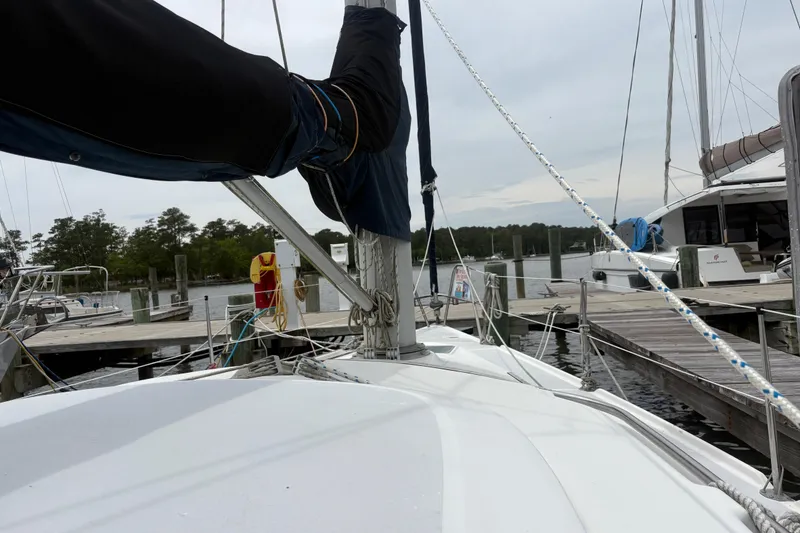 Slide: The Image of 1989 Hunter Vision 32 sailboat docked at a marina with surrounding boats. - 14