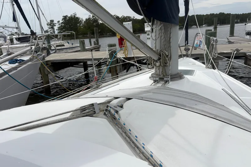 Slide: The Image of 1989 Hunter Vision 32 sailboat docked at a marina, showing deck and rigging. - 15