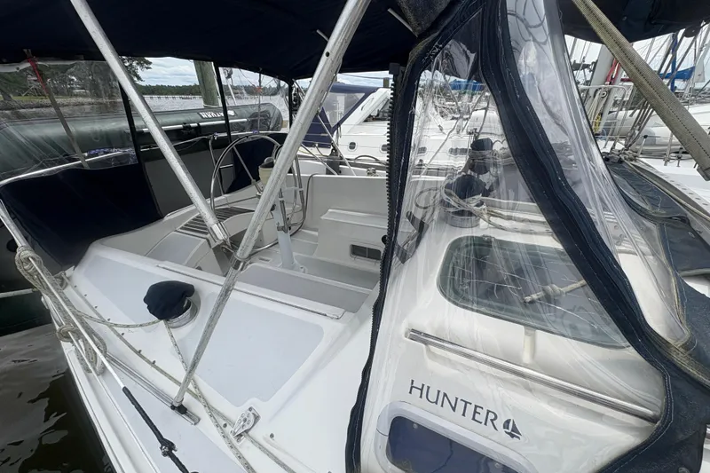 Slide: The Image of 1989 Hunter Vision 32 sailboat with cockpit and canopy, docked at marina. - 18