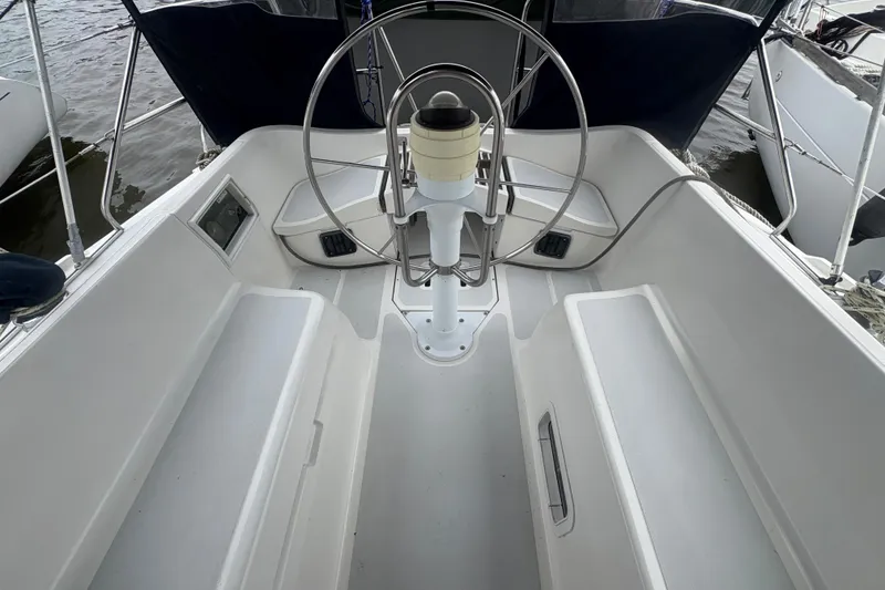 Slide: The Image of Cockpit of 1989 Hunter Vision 32 sailboat with steering wheel and seating. - 22