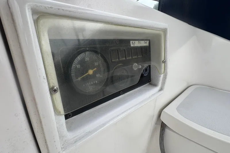 Slide: The Image of Instrument panel of a 1989 Hunter Vision 32 sailboat, featuring a tachometer and gauges. - 25