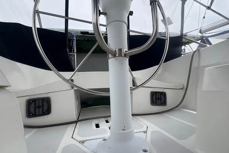 Slide: The Image of Cockpit of 1989 Hunter Vision 32 sailboat with steering wheel and seating area. - 26