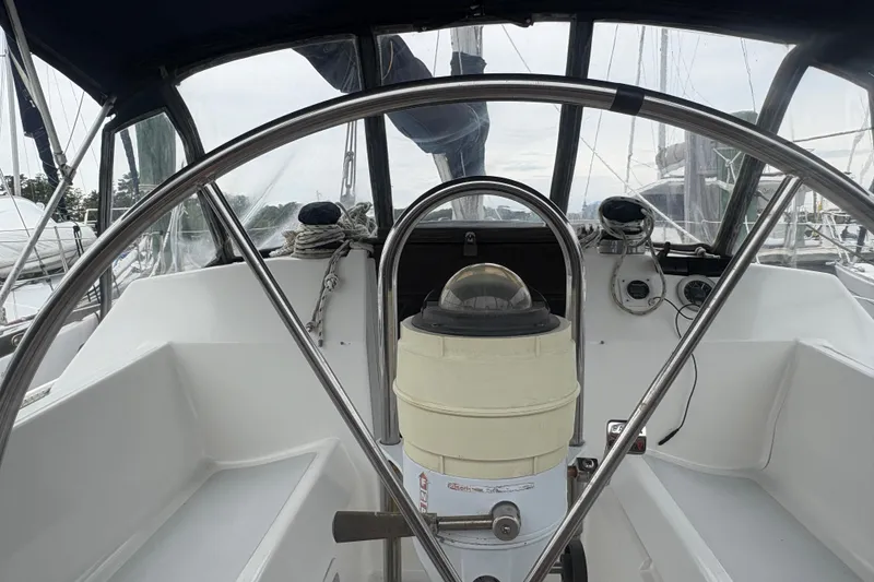 Slide: The Image of Cockpit of 1989 Hunter Vision 32 sailboat with steering wheel and navigation instruments. - 32