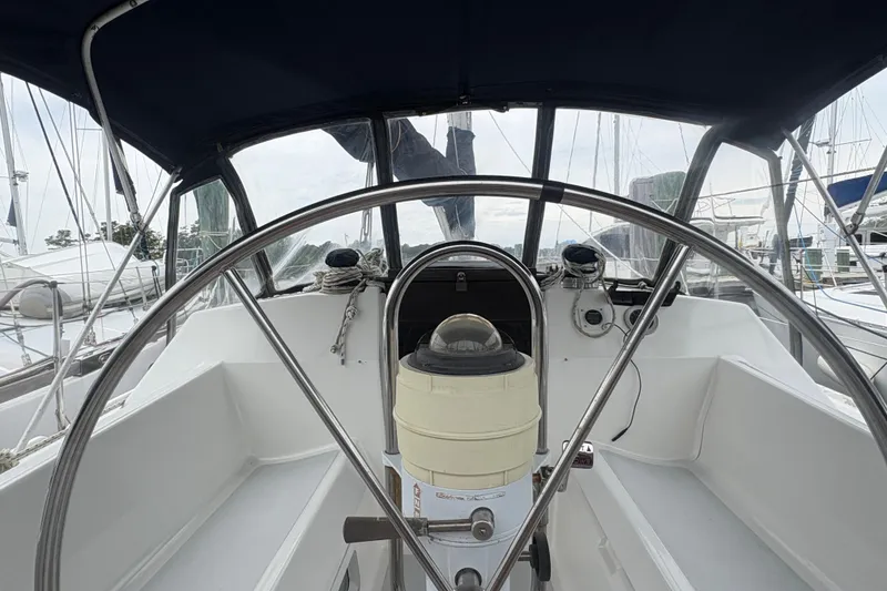 Slide: The Image of Cockpit view of 1989 Hunter Vision 32 sailboat with steering wheel and navigation instruments. - 33
