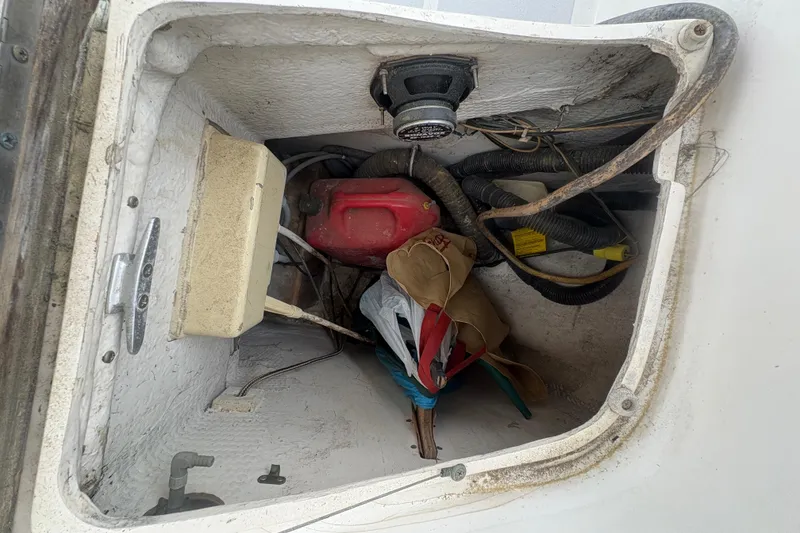 Slide: The Image of Storage compartment of 1989 Hunter Vision 32 sailboat with equipment and supplies. - 38