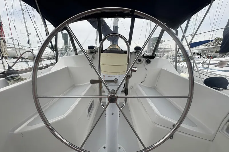 Slide: The Image of Cockpit view of 1989 Hunter Vision 32 sailboat with steering wheel and seating. - 41