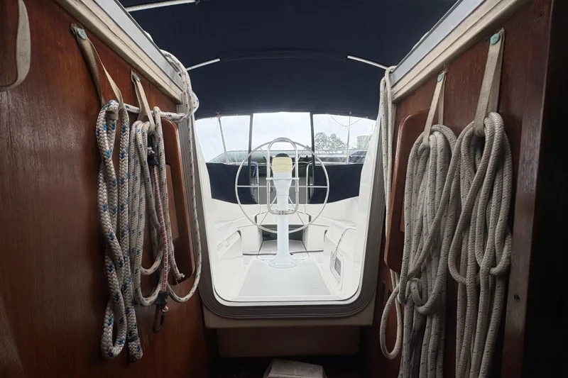 Slide: The Image of Interior view of 1989 Hunter Vision 32 sailboat cockpit with ropes and steering wheel. - 42
