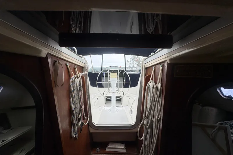 Slide: The Image of Interior view of 1989 Hunter Vision 32 sailboat, showcasing cockpit and ropes. - 43