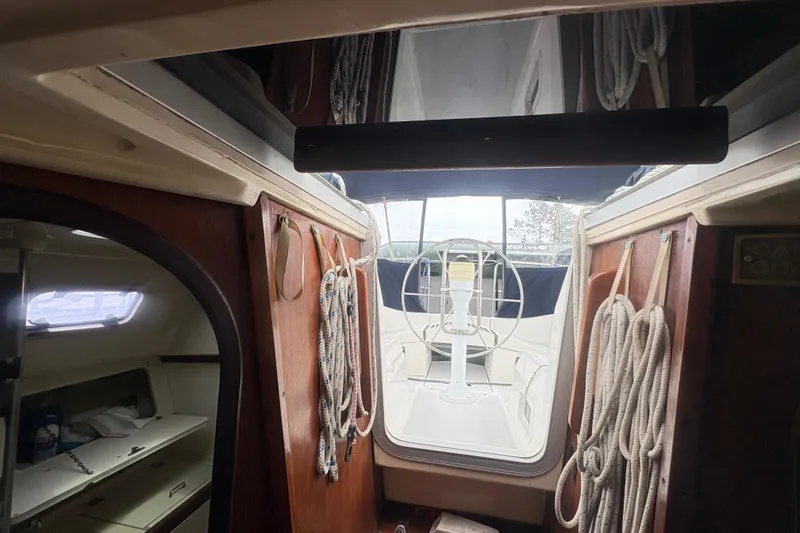 Slide: The Image of Interior view of 1989 Hunter Vision 32 sailboat, showcasing ropes and cockpit area. - 44