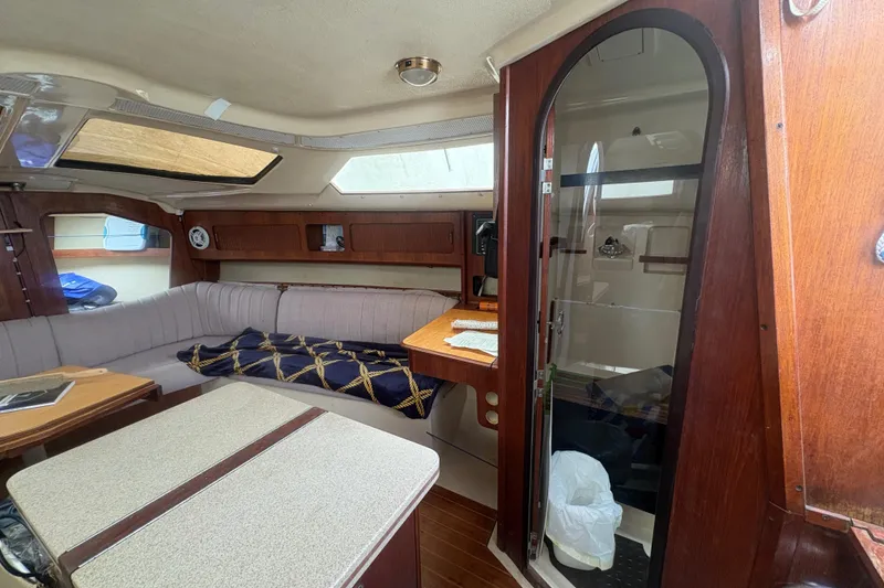 Slide: The Image of Interior of 1989 Hunter Vision 32 sailboat with cozy seating and wooden accents. - 45