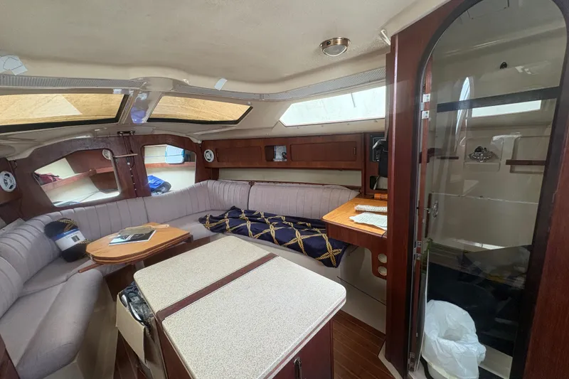 Slide: The Image of Interior of 1989 Hunter Vision 32 sailboat with cozy seating and wooden accents. - 46
