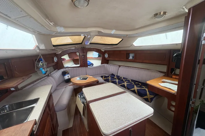 Slide: The Image of Interior of 1989 Hunter Vision 32 sailboat with cozy seating and wooden cabinetry. - 47