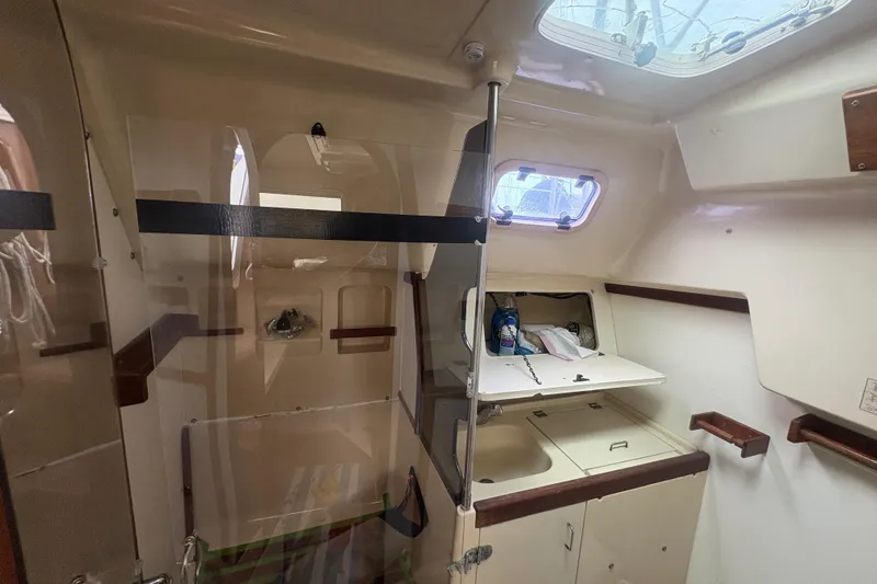Slide: The Image of Interior of 1989 Hunter Vision 32 sailboat with compact kitchen area. - 50