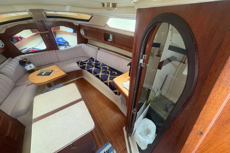 Slide: The Image of Interior of 1989 Hunter Vision 32 sailboat with cozy seating and wooden finishes. - 51