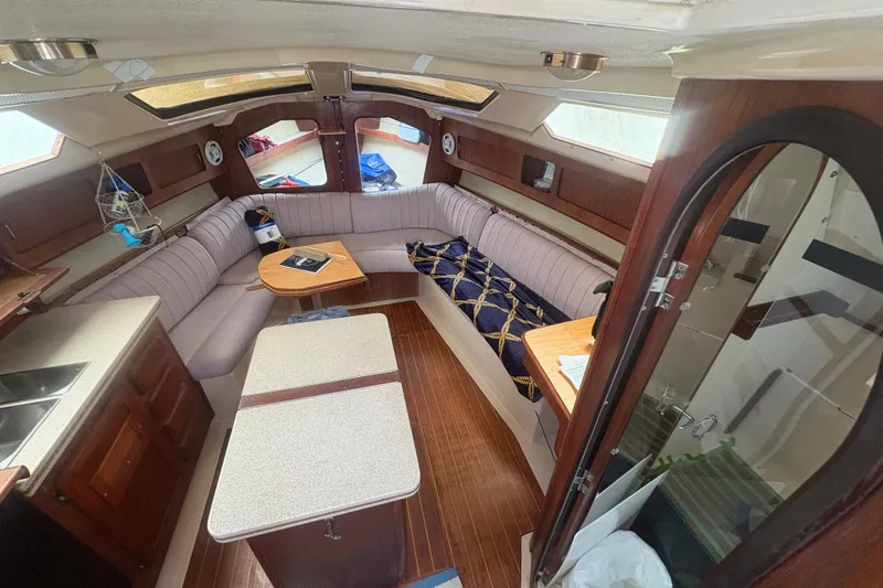 Slide: The Image of Interior of 1989 Hunter Vision 32 sailboat with cozy seating and wooden finishes. - 52