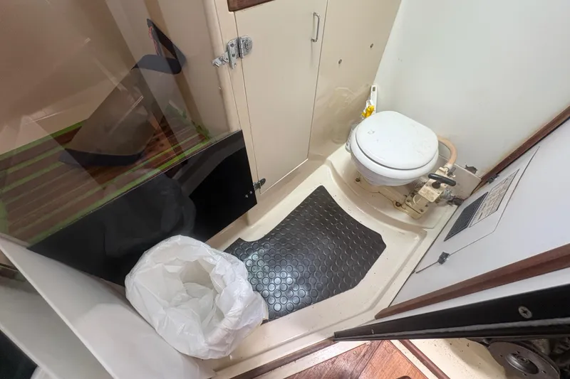 Slide: The Image of Compact bathroom in 1989 Hunter Vision 32 sailboat with toilet and storage cabinet. - 56