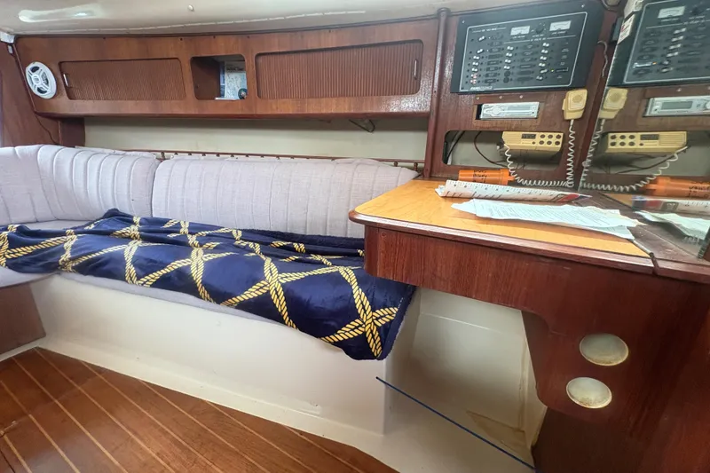 Slide: The Image of Interior of 1989 Hunter Vision 32 sailboat with wood paneling and navigation equipment. - 61