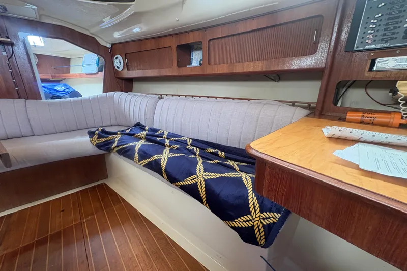Slide: The Image of Interior of 1989 Hunter Vision 32 sailboat with cozy seating and nautical decor. - 62