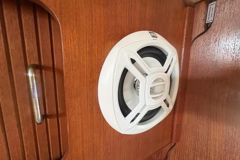 Slide: The Image of White speaker mounted on wooden interior of 1989 Hunter Vision 32 boat. - 64