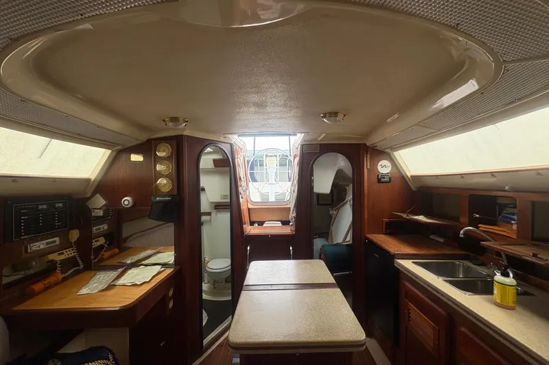 Slide: The Image of Interior of 1989 Hunter Vision 32 sailboat with wood finish and compact kitchen area. - 65