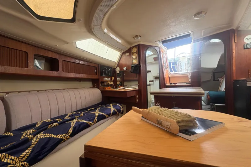 Slide: The Image of Interior of 1989 Hunter Vision 32 sailboat with cozy seating and wooden accents. - 66