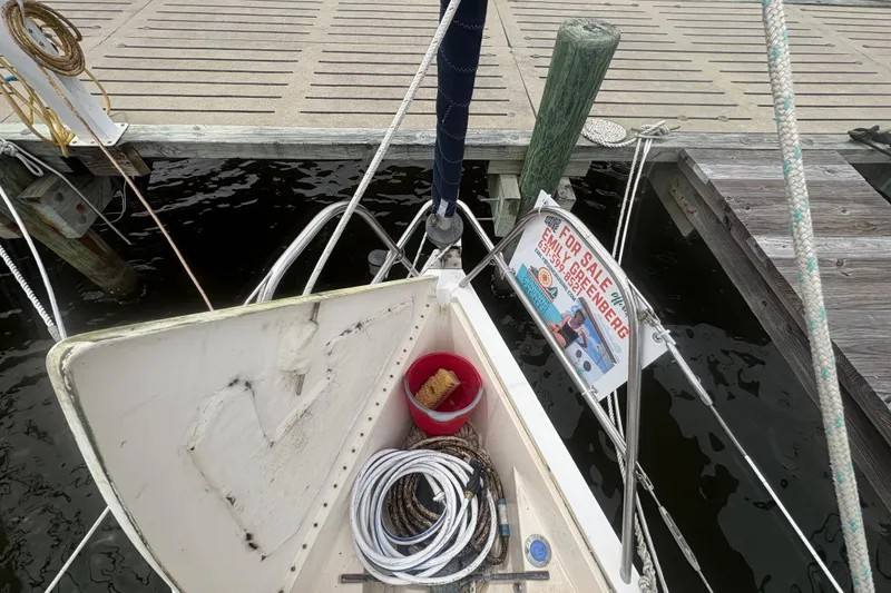 Slide: The Image of 1989 Hunter Vision 32 sailboat docked, with "For Sale" sign and cleaning supplies visible. - 7