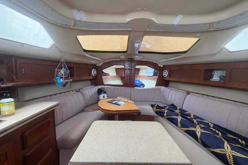 Slide: The Image of Interior of 1989 Hunter Vision 32 sailboat with cozy seating and wooden accents. - 70