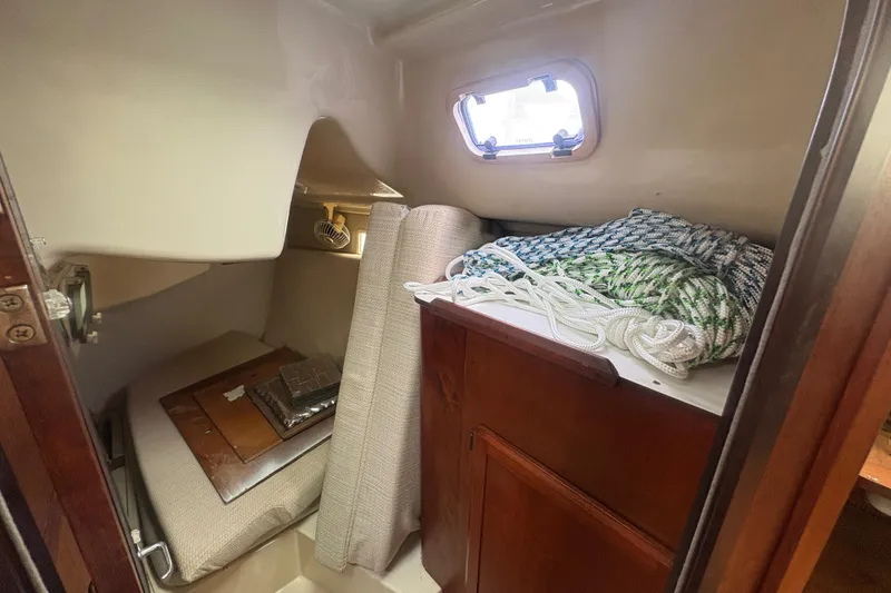 Slide: The Image of Interior cabin of 1989 Hunter Vision 32 sailboat with ropes and storage. - 73