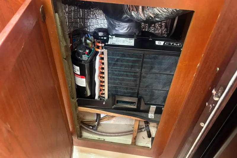 Slide: The Image of Air conditioning unit inside a 1989 Hunter Vision 32 sailboat cabinet. - 75