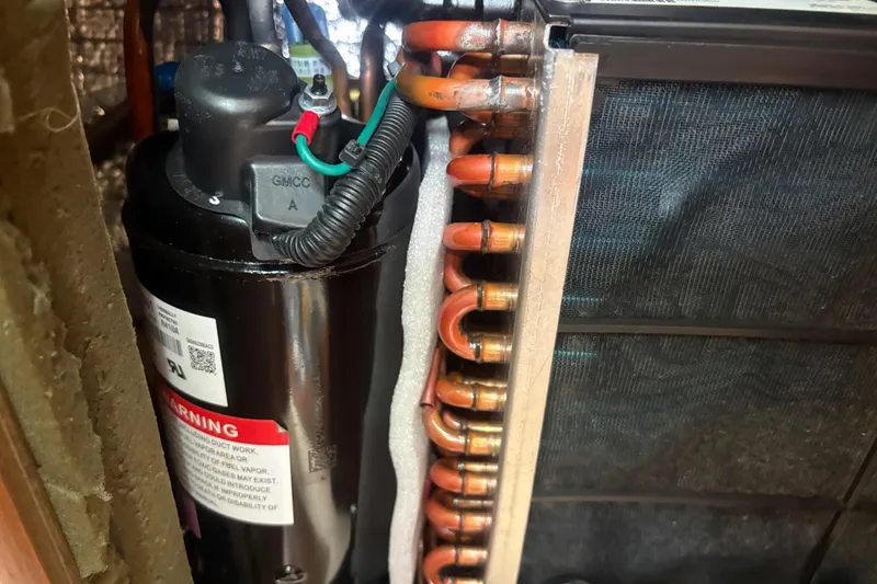 Slide: The Image of Close-up of HVAC components in a 1989 Hunter Vision 32, showing copper coils and compressor. - 77
