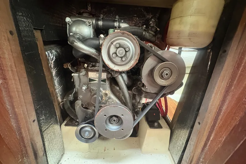 Slide: The Image of Engine compartment of a 1989 Hunter Vision 32 sailboat, showcasing mechanical components. - 79