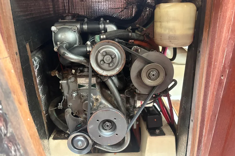 Slide: The Image of Engine compartment of a 1989 Hunter Vision 32 sailboat, showcasing mechanical components. - 81