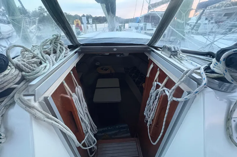 Slide: The Image of Interior view of 1989 Hunter Vision 32 sailboat with ropes and cabin entrance. - 83