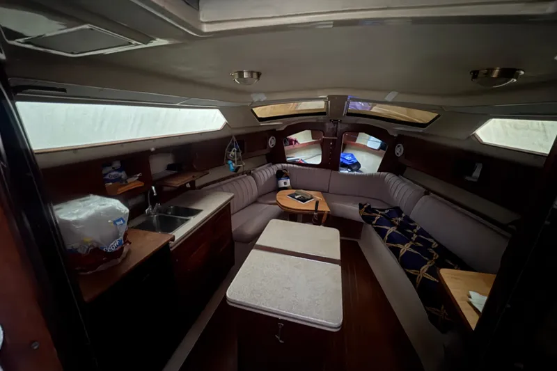 Slide: The Image of Interior of 1989 Hunter Vision 32 sailboat with cozy seating and kitchenette. - 84
