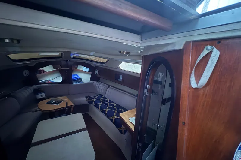 Slide: The Image of Interior of 1989 Hunter Vision 32 sailboat with cozy seating and wooden accents. - 85