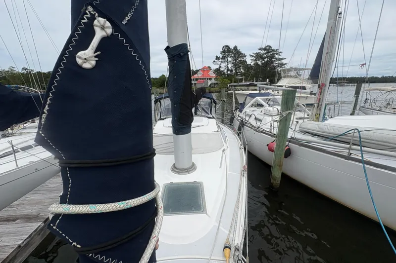 Slide: The Image of 1989 Hunter Vision 32 sailboat docked at marina with other boats. - 9