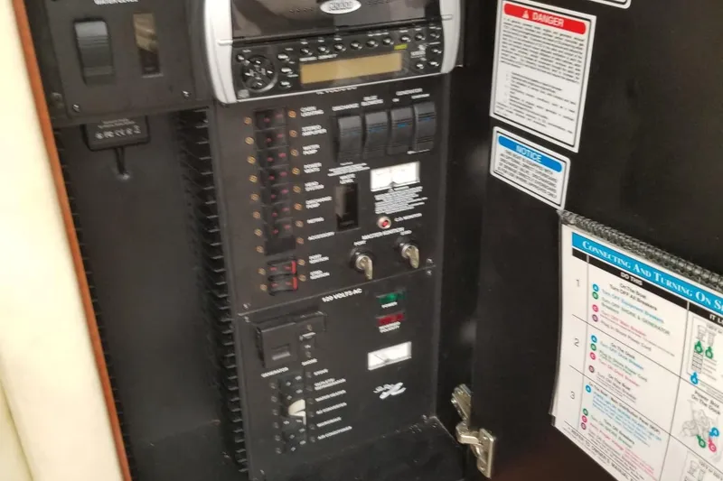 Slide: The Image of Electrical control panel on a 2004 Sea Ray 300 Sundancer boat. - 18