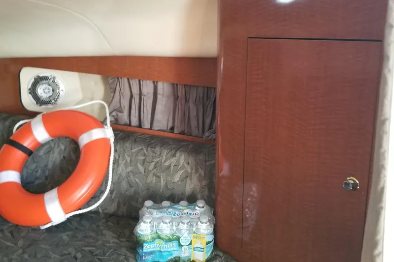 Slide: The Image of Interior of 2004 Sea Ray 300 Sundancer with life preserver and bottled water. - 19