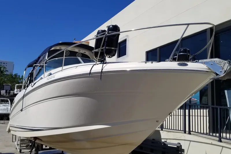 Slide: The Image of 2004 Sea Ray 300 Sundancer boat displayed outdoors on a sunny day. - 3