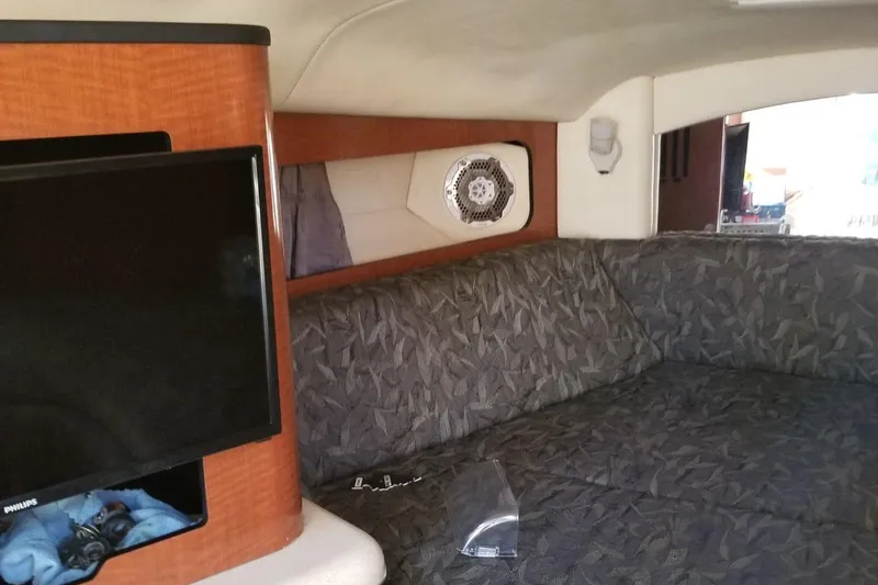 Slide: The Image of Interior of 2004 Sea Ray 300 Sundancer with TV and patterned seating. - 7