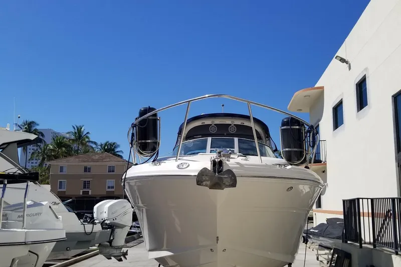 Slide: The Image of 2004 Sea Ray 300 Sundancer boat docked under clear blue sky. - 8