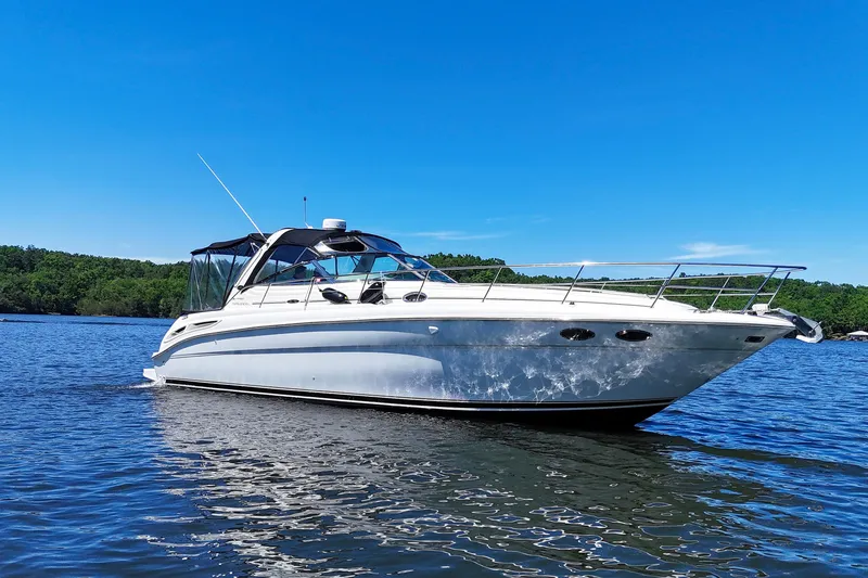 Slide: The Image of 2003 Sea Ray 380 Sundancer yacht on calm water under clear blue sky. - 1