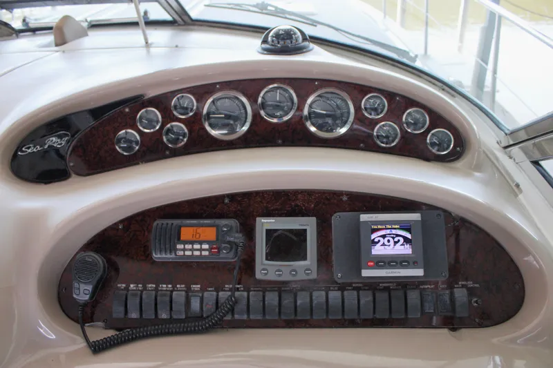 Slide: The Image of Control panel of a 2003 Sea Ray 380 Sundancer boat with gauges and navigation equipment. - 18
