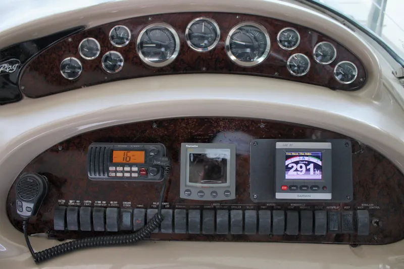 Slide: The Image of Dashboard of a 2003 Sea Ray 380 Sundancer with gauges and navigation equipment. - 19