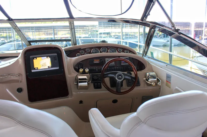 Slide: The Image of Cockpit of 2003 Sea Ray 380 Sundancer with steering wheel and navigation controls. - 21