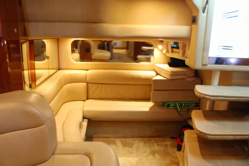 Slide: The Image of Luxurious interior of a 2003 Sea Ray 380 Sundancer yacht with beige leather seating. - 30