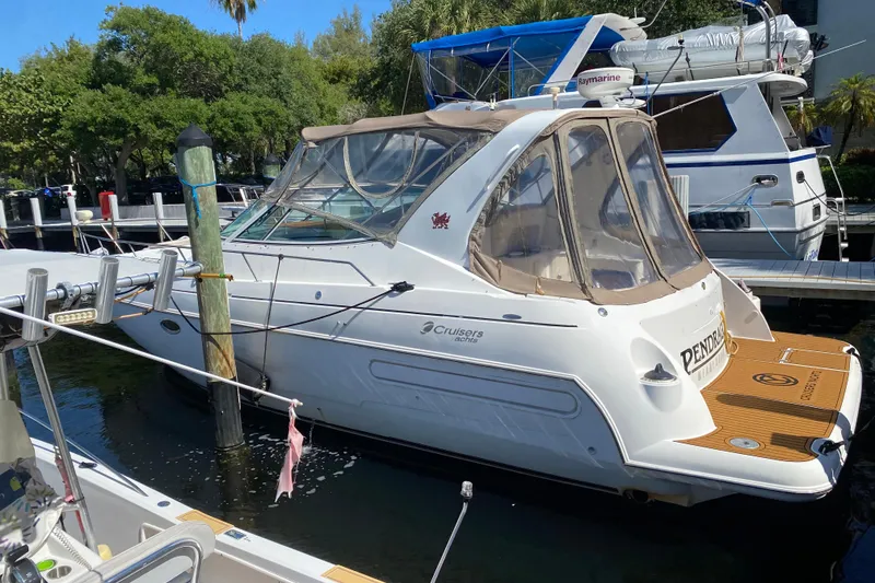 Slide: The Image of 2002 Cruisers Yachts 3572 Express docked at marina, featuring sleek design and covered cockpit. - 10