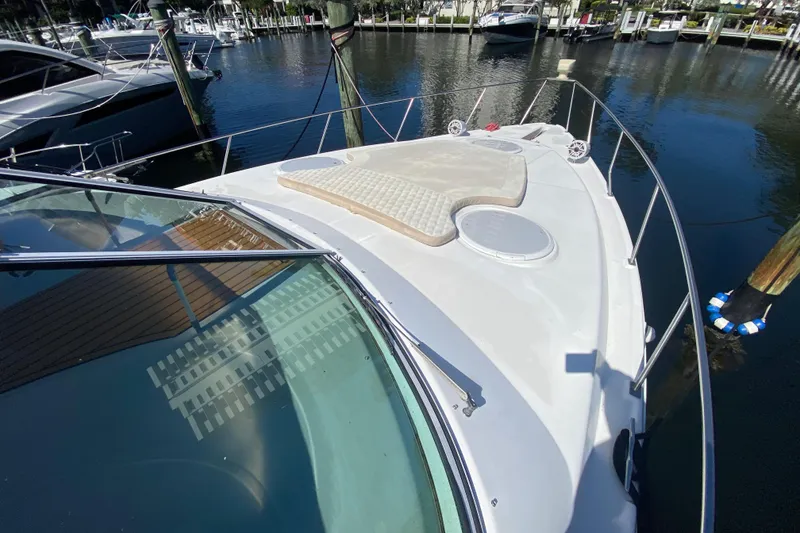 Slide: The Image of 2002 Cruisers Yachts 3572 Express boat docked at marina, featuring spacious deck area. - 12