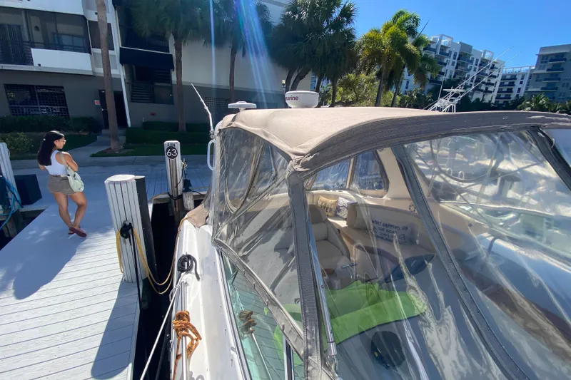 Slide: The Image of 2002 Cruisers Yachts 3572 Express docked, with a person walking nearby. - 17