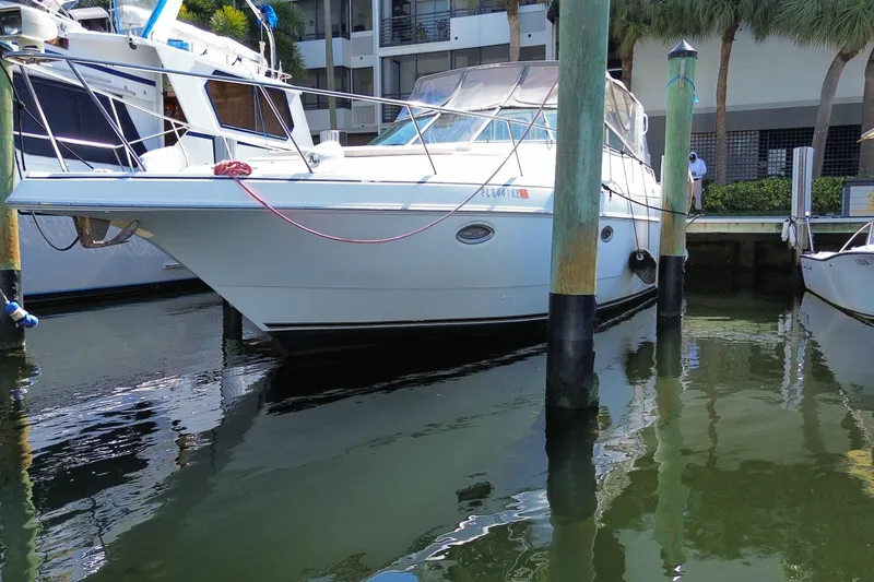 Slide: The Image of 2002 Cruisers Yachts 3572 Express docked at marina, reflecting on calm water. - 2